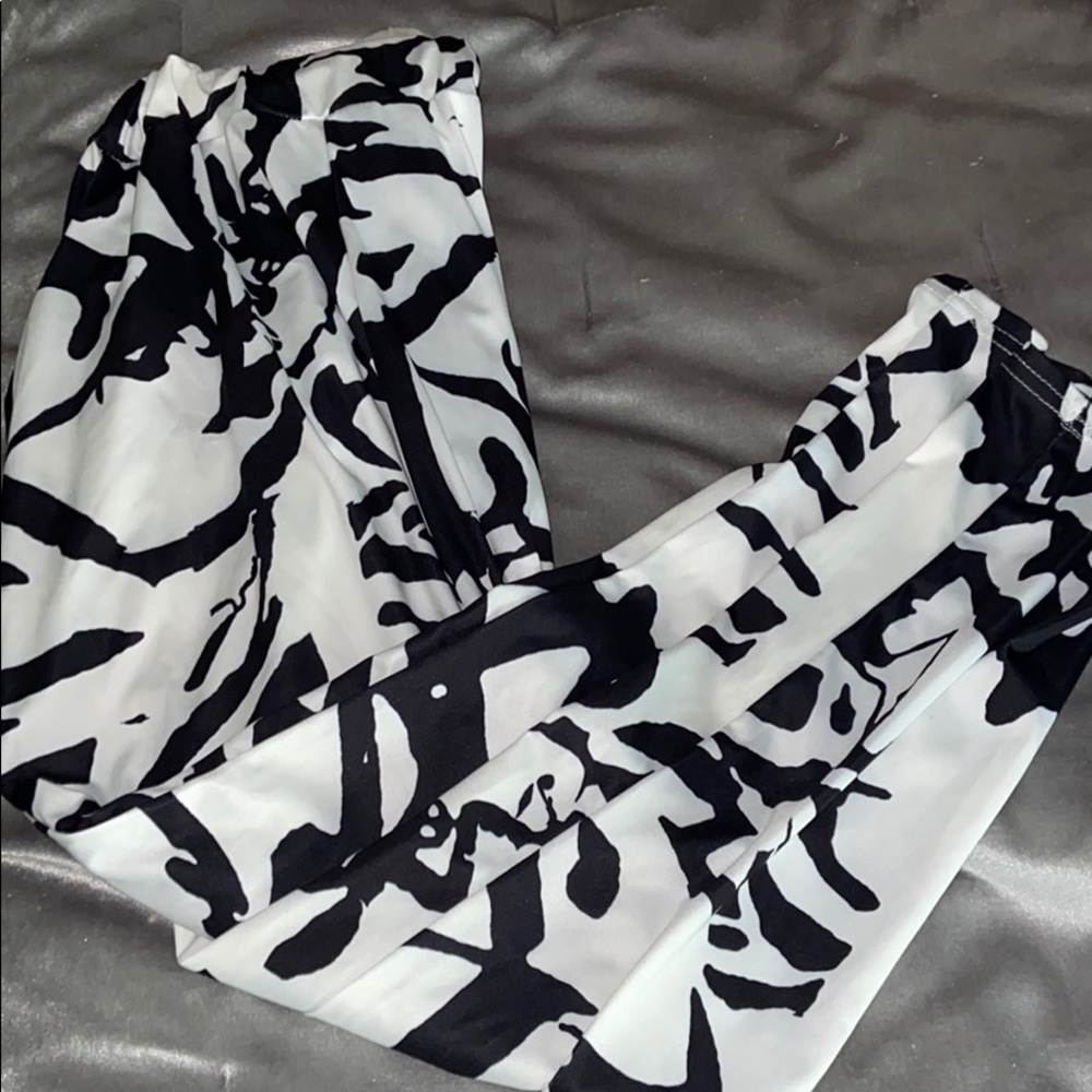Stylish cow print pants with pockets.